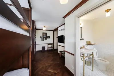 a room with a bed and a sink and a toilet at Jefferson Hotel in Miami