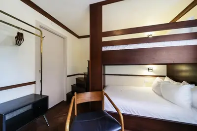 a bedroom with a bunk bed and a chair at Jefferson Hotel in Miami