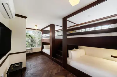 a room with two bunk beds and a desk at Jefferson Hotel in Miami