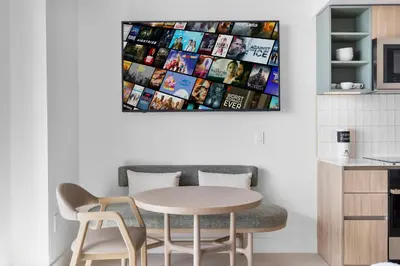 a table and chairs in a kitchen with a picture on the wall at Luxury Studio on 47th! Floor in Downtown Miami in Miami