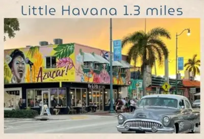 an old car driving down a street in a city at Stay Where Miami Comes Alive in Miami