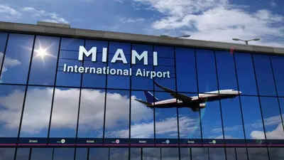 an airplane is reflected in the windows of an airport at Stay Where Miami Comes Alive in Miami