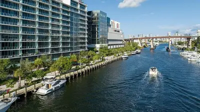 a boat in a river in a city with buildings at Stay Where Miami Comes Alive in Miami