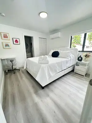 a white bedroom with a large bed and a window at 5 Star Feel in Miami Prime Location in Miami