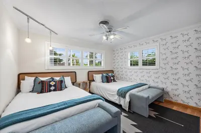 a bedroom with two beds and a ceiling fan at Centrally Located 4BD Oasis with Pool & Movie Patio in Hollywood