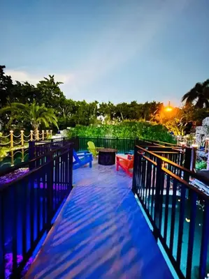 a deck with colorful chairs and a fence at Lake Of Dreams Miami House in Miami