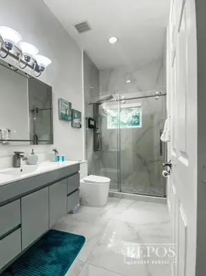 a bathroom with a shower and a sink and a toilet at Lake Of Dreams Miami House in Miami