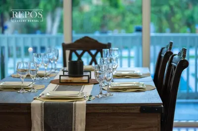 a table with wine glasses and napkins on it at Lake Of Dreams Miami House in Miami