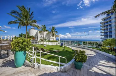 a view of the beach from the balcony of a resort at Beachfront Condo Fort Lauderdale in Fort Lauderdale