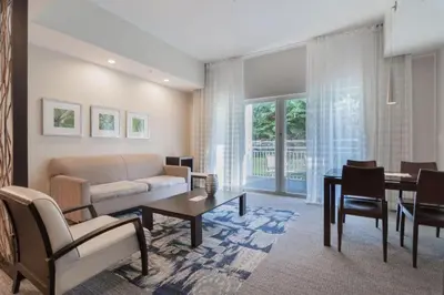 a living room with a couch and a table at Doral Pool 1407 by WaveProperties in Miami