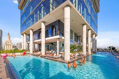 a large swimming pool with people in a building at Resort-Style Living 1BR Apt in Downtown Miami in Miami