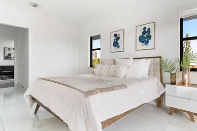 a white bedroom with a large bed and a window at April Sale! 4BR - Private Yard, Grill, Soaking Tub, Near Coral Gables & MIA Airport in Tamiami