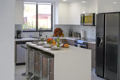 a kitchen with stainless steel appliances and a counter top at April Sale! 4BR - Private Yard, Grill, Soaking Tub, Near Coral Gables & MIA Airport in Tamiami