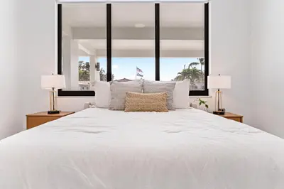 a bedroom with a large white bed with two lamps at April Sale! 4 BR - Private Pool, Grill, Soaking Tub, Near Coral Gables & MIA Airport in Miami