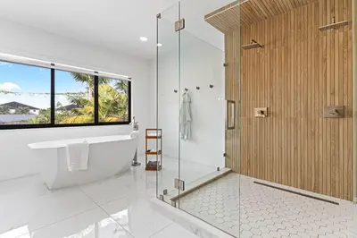 a bathroom with a tub and a shower with a window at April Sale! 4 BR - Private Pool, Grill, Soaking Tub, Near Coral Gables & MIA Airport in Miami