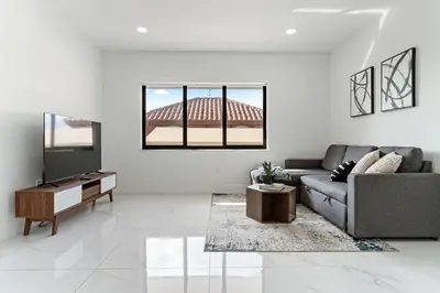 a living room with a couch and a television at April Sale! 4 BR - Private Pool, Grill, Soaking Tub, Near Coral Gables & MIA Airport in Miami