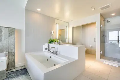 a white bathroom with a large tub and a shower at Balcony with Ocean View Fort Lauderdale Oasis! in Fort Lauderdale