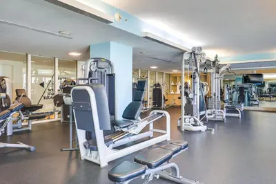 a gym with several tread machines in a room at Balcony with Ocean View Fort Lauderdale Oasis! in Fort Lauderdale