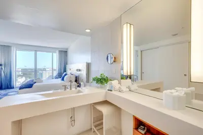a bathroom with two sinks and a large mirror at Walk to Beach and Dining! Luxe Fort Lauderdale Condo in Fort Lauderdale