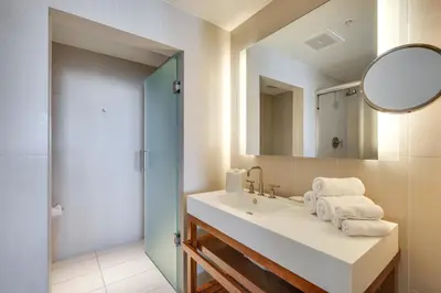 a bathroom with a sink and a mirror at Walk to Beach and Dining! Luxe Fort Lauderdale Condo in Fort Lauderdale