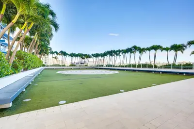 a golf course with palm trees in the background at Walk to Beach and Dining! Luxe Fort Lauderdale Condo in Fort Lauderdale