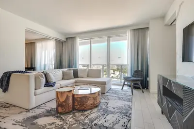 a living room with a white couch and a fireplace at Walk to Beach and Dining! Luxe Fort Lauderdale Condo in Fort Lauderdale