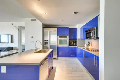 a kitchen with blue cabinets and a sink at Walk to Bars and Eats! Luxe Ft Lauderdale Condo in Fort Lauderdale