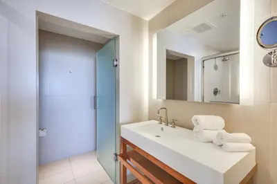 a bathroom with a sink and a mirror at Walk to Bars and Eats! Luxe Ft Lauderdale Condo in Fort Lauderdale