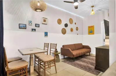 a living room with a couch and a table and chairs at No name in Miami