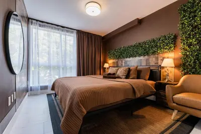 a hotel room with a bed and a chair at MONROE APART HOTEl in Hollywood