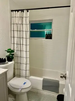 a bathroom with a toilet and a tub and a shower at New Brisa Marina in Fort Lauderdale