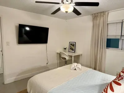 a bedroom with a bed and a flat screen tv at New Brisa Marina in Fort Lauderdale