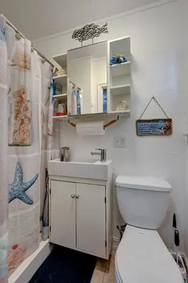 a bathroom with a toilet and a sink and a shower at Hidden Getaway in Fort Lauderdale