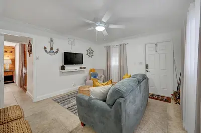 a living room with a couch and a ceiling fan at Hidden Getaway in Fort Lauderdale