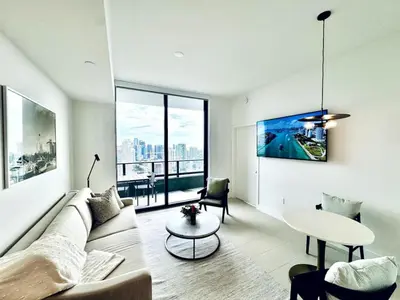 a living room with a couch and a table at 48th Floor PH collection 1 BD Brand New Downtown in Miami