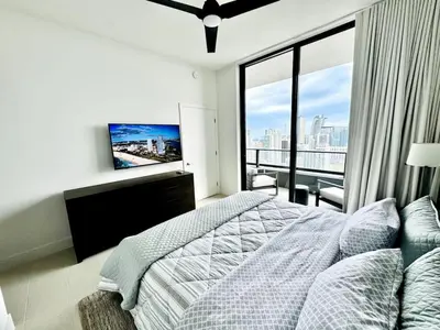 a bedroom with a bed and a large window at 48th Floor PH collection 1 BD Brand New Downtown in Miami
