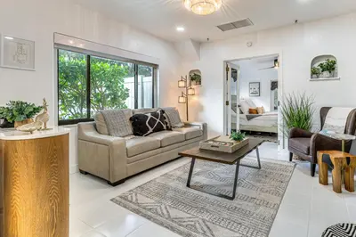 a living room with a couch and a table at The Peacock Bungalow Near Fort Lauderdale Beach! in Fort Lauderdale