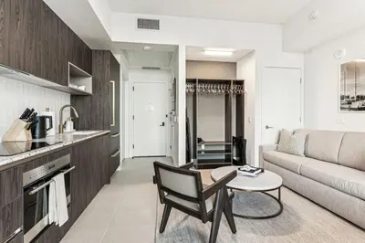 a living room with a couch and a table at Lux 48th Floor Condo, Water views, Pool, Gym and Spa in Miami