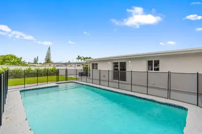 a swimming pool in front of a building at Miami Japandi Style Pool - BBQ in Miami