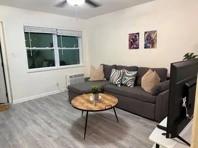 a living room with a couch and a table at New comfortable and youthful sport in Fort Lauderdale
