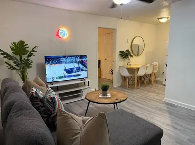 a living room with a couch and a tv and a table at New comfortable and youthful sport in Fort Lauderdale