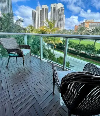 a balcony with chairs and a view of the city at Spacious 3 BR plus 1 office and 2 BA with Free parking Just in front beach in Sunny Isles Beach
