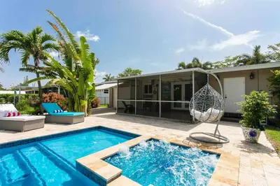 a backyard with a swimming pool and a house at MIAMI Art Villa Heated Saltwater Pool with SPA EV in Dania Beach