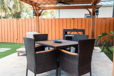 a wooden table and chairs on a patio at Luxury Retreat 3B ,2Ba POOL , Coral Gables Center in Miami