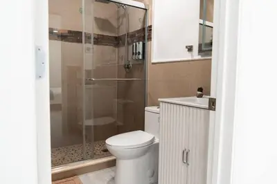 a bathroom with a toilet and a glass shower at Luxury Retreat 3B ,2Ba POOL , Coral Gables Center in Miami
