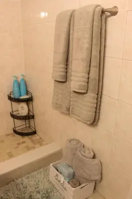 a bathroom with white towels and a sink and a tub at Beach Escape private studio in Sunny Isles Beach