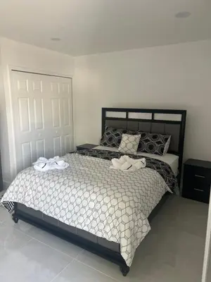 a bedroom with a bed with two towels on it at Luxury Studio in Miami