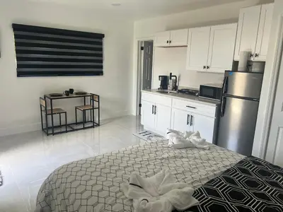a kitchen with a bed and a refrigerator at Luxury Studio in Miami
