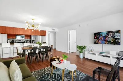 a living room and kitchen with a couch and a table at Exclusive 1BR Apartment on 35th floor in Miami