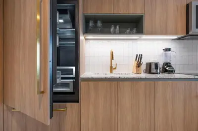 a kitchen with wooden cabinets and a counter top at On 46th Floor! Amazing Views and Free Parking in Miami